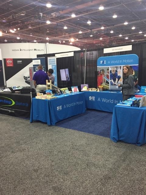 Trade show booth with blue promotional tables